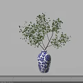 Blue and White Floral Patterned Vase with Green Leafy Branches for Home Decor