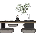 Modern Tea Table Set with Cushioned Stools Teapot Teacups and Green Plant