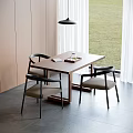 Modern Dining Table With Black Chairs And Light Gray Seats By Window Green Lawn View