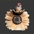 A red headed bird perched on yellow sunflower shaped decorative ornament