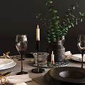 Tableware Set with Black White Plates Wine Glasses Golden Cutlery Green Plant and Candles