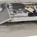 Burned Debris Of Damaged Item On Road Surface With Charred And Broken Parts