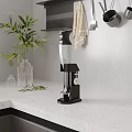 Modern Kitchen Countertop With Black Blender Green Plant And Hanging Utensils