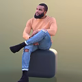 Man Sitting On Grey Cube Stool Wearing Orange Sweater Blue Ripped Jeans And Black Shoes