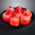 Vibrant Red Ripe Pomegranates Placed On A Black Plate For Fresh