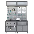 Organized Hardware Tools on Pegboard Wall with Hanging Hammers Pliers Blueprints and Drawer Cabinet