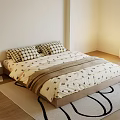Cozy Double Bed with Plaid Pillows Patterned Bedspread Nightstand Lamp Rug and Green Plant