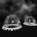Two Purple Chandeliers With Curved Strands And White Lights On Dark Background