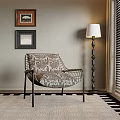 Stylish Accent Chair With Metal Frame Patterned Cushion Floor Lamp Framed Art And Area Rug