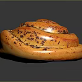 Freshly Baked Cinnamon Roll With Spiral Shape Golden Brown And Cinnamon Swirls On Black Surface