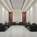 Hotel Public Lounge Area Featuring White Walls Brown Wooden Panels Black Sofas And Green Plants