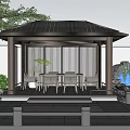 Rockery Stones In Outdoor Pavilion With Wicker Chairs White Table And Green Plants