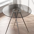 Modern Round Dining Table With Glass Top And Metal Legs On Wooden Floor