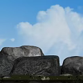 Large Stones In Natural Setting With Green Grass Red Flowers And Blue Sky