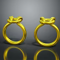 Elegant Gold Rings With Intricate Knot Design And Shiny Surface