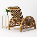 Rattan Leisure Chair with Black Cushion Decorative Pillow Side Table and Green Plant