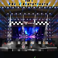 Vibrant Live Music Festival Stage With Bright Lights And Audience Light Sticks