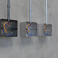 Switch Panels Black and Silver with Yellow and Blue Wires Mounted on Grey Wall
