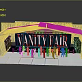 Vanity Fair Stage Setup With Group Of Performers In Orange Outfits On White Platform