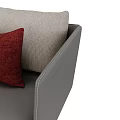 Modern Gray Leather Chaise Lounge With Red And Beige Pillows And Metal Legs