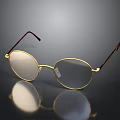 Round Eyeglasses With Gold Frame And Brown Temple Arms On Reflective Black Surface