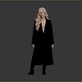 Woman With Long Blonde Hair Standing In Black Coat And Black Boots On Gray Background