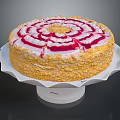 Round Decorative Cake With Red And White Cream Swirls And Yellow Crumbs On White Stand