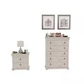 Modern White Dresser With Multiple Drawers And Decorative Items On Top Beside Small Side Cabinet