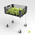 Practical Storage Basket With Wheels Filled With Yellow Balls And A Single Ball Beside