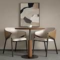 Modern Round Table And Two Chairs With Abstract Painting On Wall