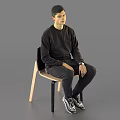 Man In Black Sweatshirt Pants And Sneakers Sitting On Chair