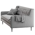 Gray Leather Sofa with Tufted Backrest Patterned Pillows Throw Blanket and Wooden Legs