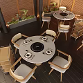 Modern Round Dining Table With Induction Cooker Light Colored Chairs Dark Wooden Floor And Green Plants