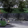 Serene Garden Landscape With Flowing Stream Lush Greenery And Modern Pavilion