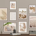 Multiple Landscape Paintings With Golden Frames Featuring Natural Elements On Beige Wall 3d model