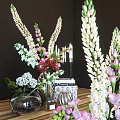 Elegant Ornamental Decor Set With Mixed Flowers Vases White Candles And Stacked Books