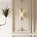 Elegant Wall Lamp With Glass Shade On White Wall With Decorative Moldings And Potted Plant