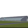 Large Greenhouse Structure for Gardening with Glass Panels and Green Grassland Surroundings