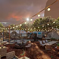 Scenic Outdoor Campsite With White Tents Dining Tables And Umbrellas Surrounded By Trees