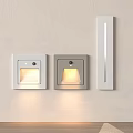 Different Designed Indoor Wall Lights One Illuminated Mounted On Light Colored Wall