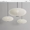 Three White Minimalist Pendant Lights With Paper Shades Hanging Oval Shapes Gray Background