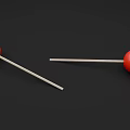 Two Vibrant Red Lollipops With Wooden Sticks On Black Background