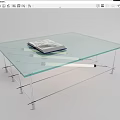 Glass Coffee Table with Transparent Top and Metal Frame Featuring a Book on Surface