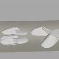 Four Pairs of White and Light Gray Slippers Placed on Striped Mat for Home Use
