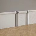 Three White Roller Blinds Mounted On Gray Wall With Herringbone Wooden Floor