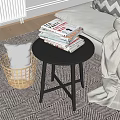 Modern Round Side Table With Stacked Books And Wicker Basket Near Bed On Patterned Rug