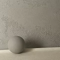 Gray Textured Wall With Spherical Object On Light Colored Surface