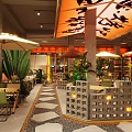 Modern Restaurant Interior With Unique Ceiling Design Green Plants And Cozy Seating Area