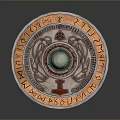 Ancient Decorative Shield With Round Design Central Green Gemstone And Intricate Runic Patterns