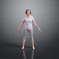 Woman Standing Barefoot In Gray T-shirt And Leggings With Arms Outstretched On Reflective Gray Floor